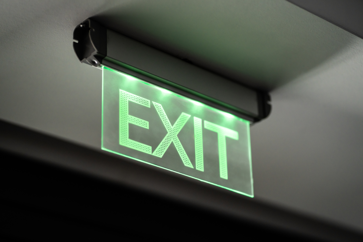 Illuminated green emergency exit sign tested by DH Electrical in Liverpool